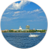 Image of town surrounded by water with boat